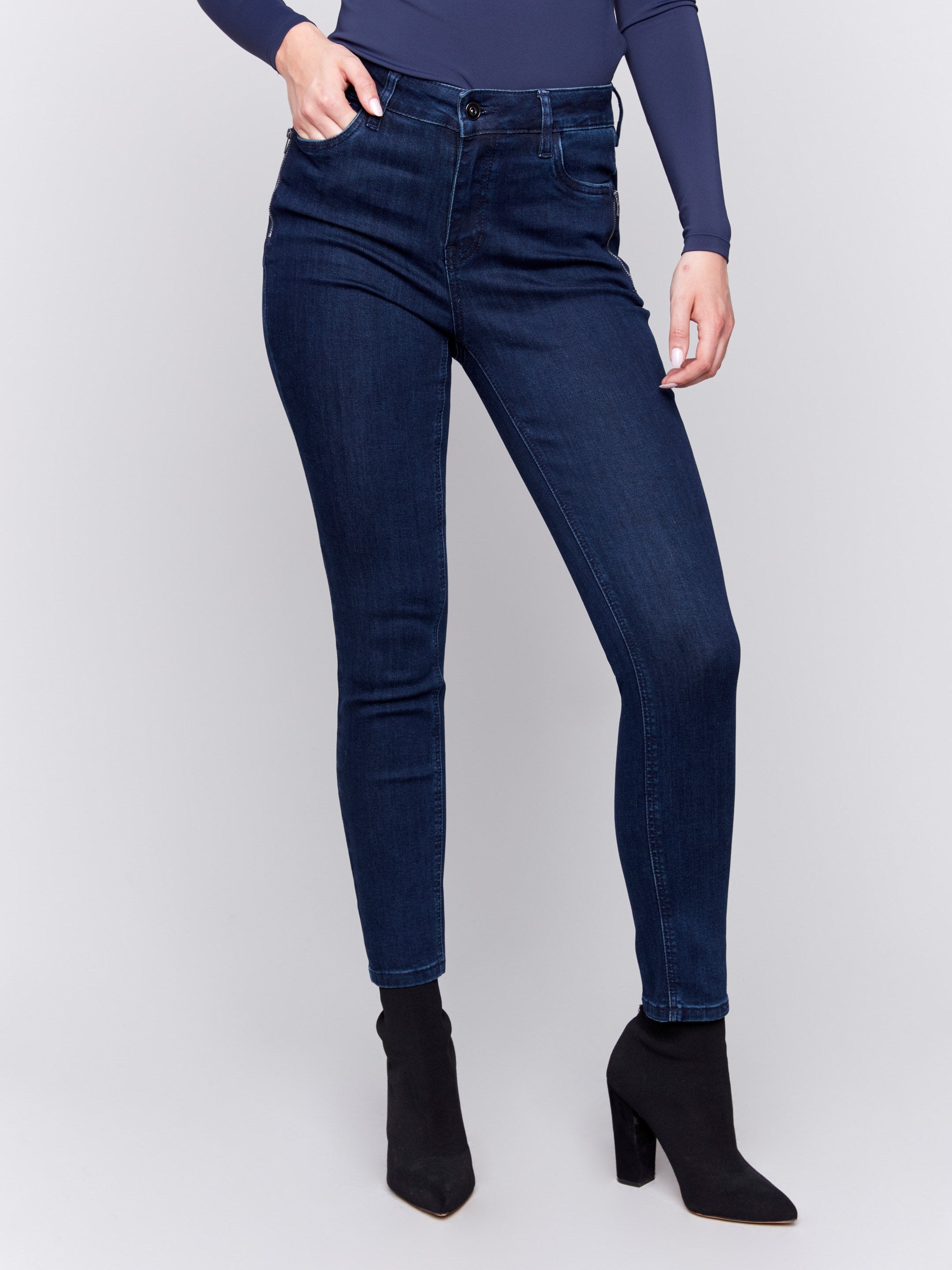 Blue black skinny jeans with a skinny fit, mid-rise, and side zipper pocket details by Charlie B.