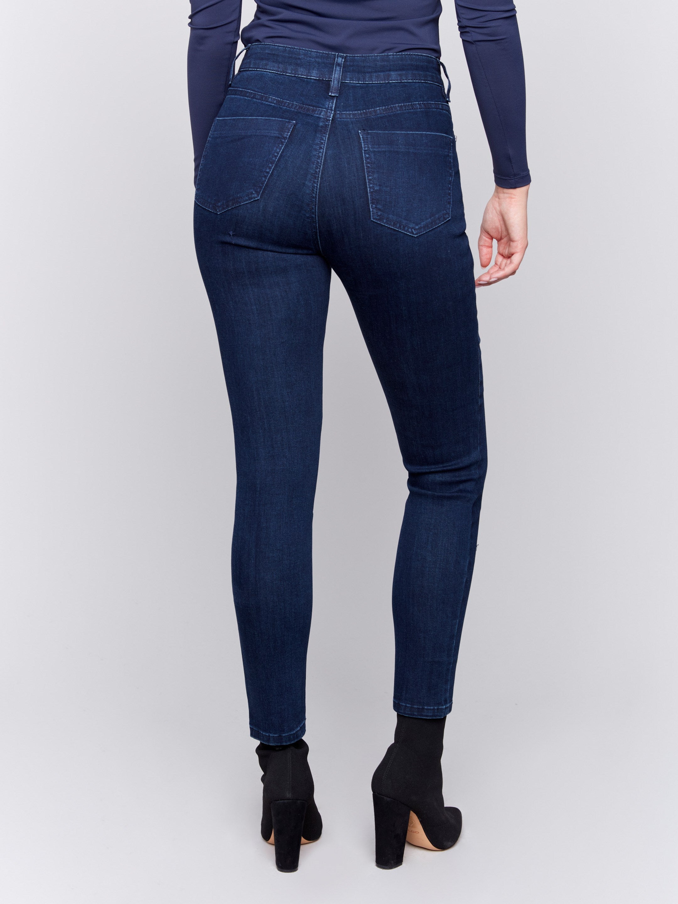 Blue black skinny jeans with a skinny fit, mid-rise, and side zipper pocket details by Charlie B.