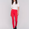 Cranberry red skinny twill pants with a mid-rise waist, skinny fit, and side zipper pocket details by Charlie B.