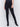 Black skinny twill pants with a mid-rise waist, skinny fit, and front zipper pocket detail by Charlie B.