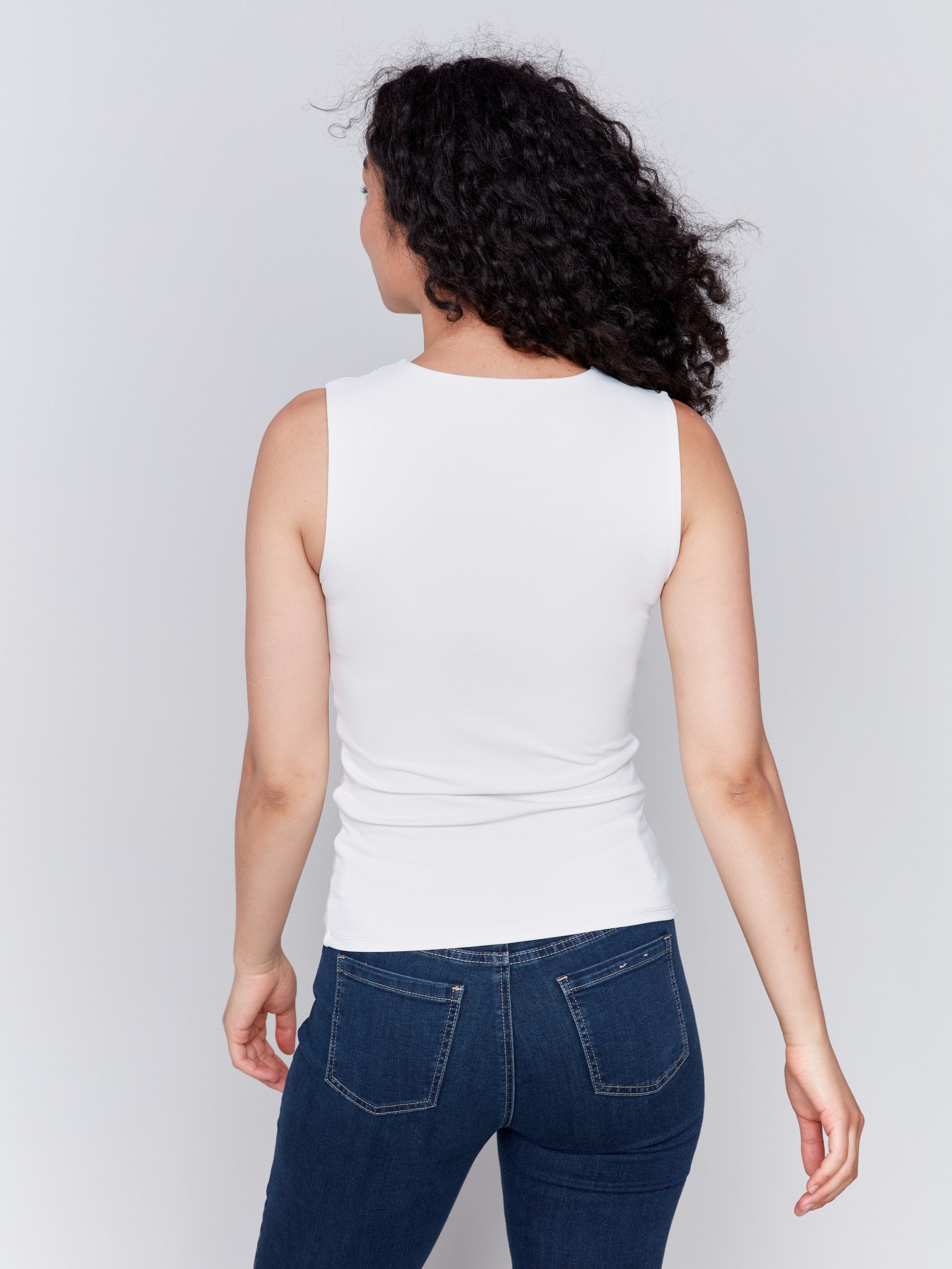 Natural white sleeveless super stretch top with a crew neckline by Charlie B.