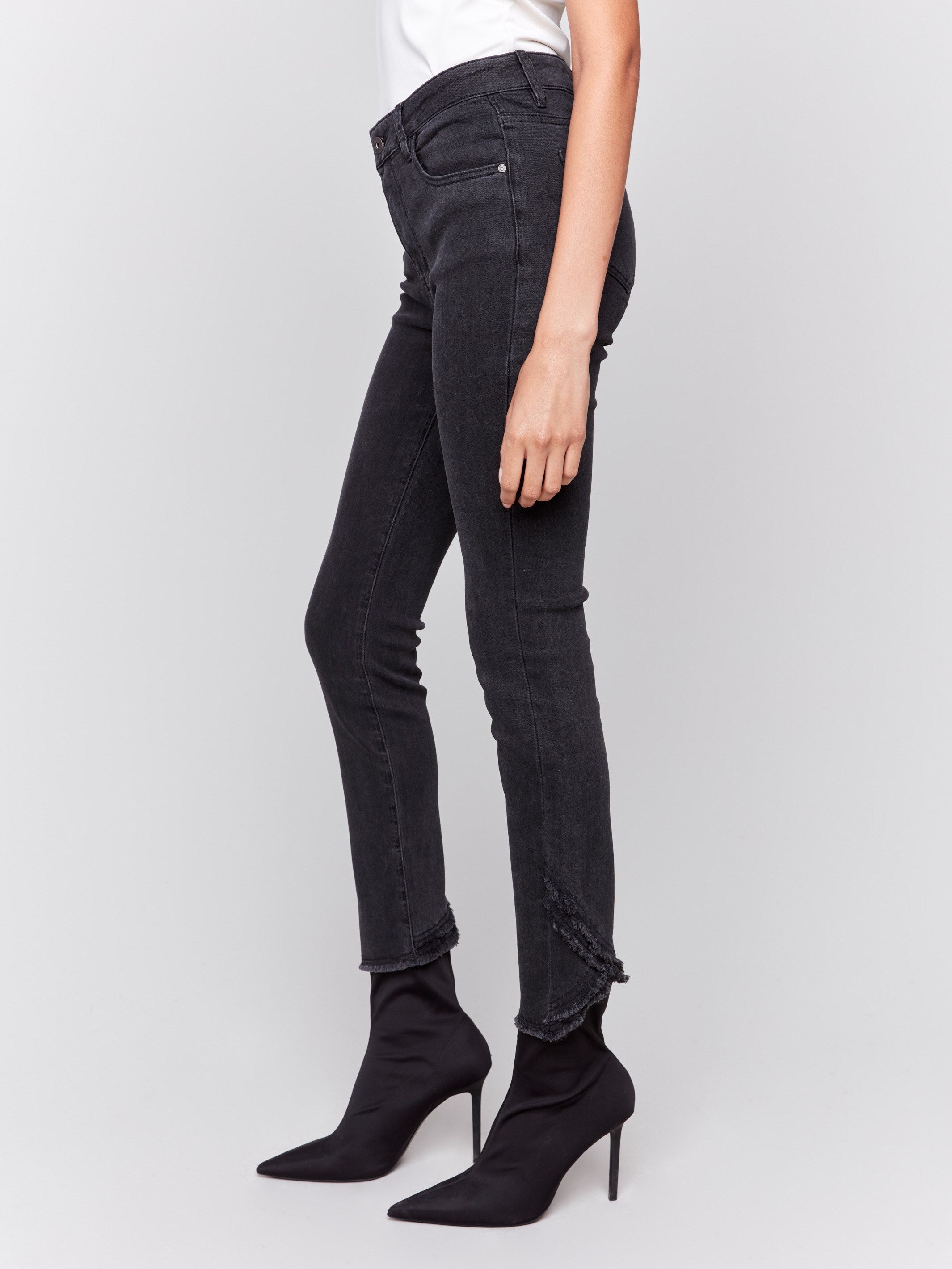 Charcoal slim fit jeans with frayed tulip hem, featuring a five-pocket design and button closure by Charlie B.