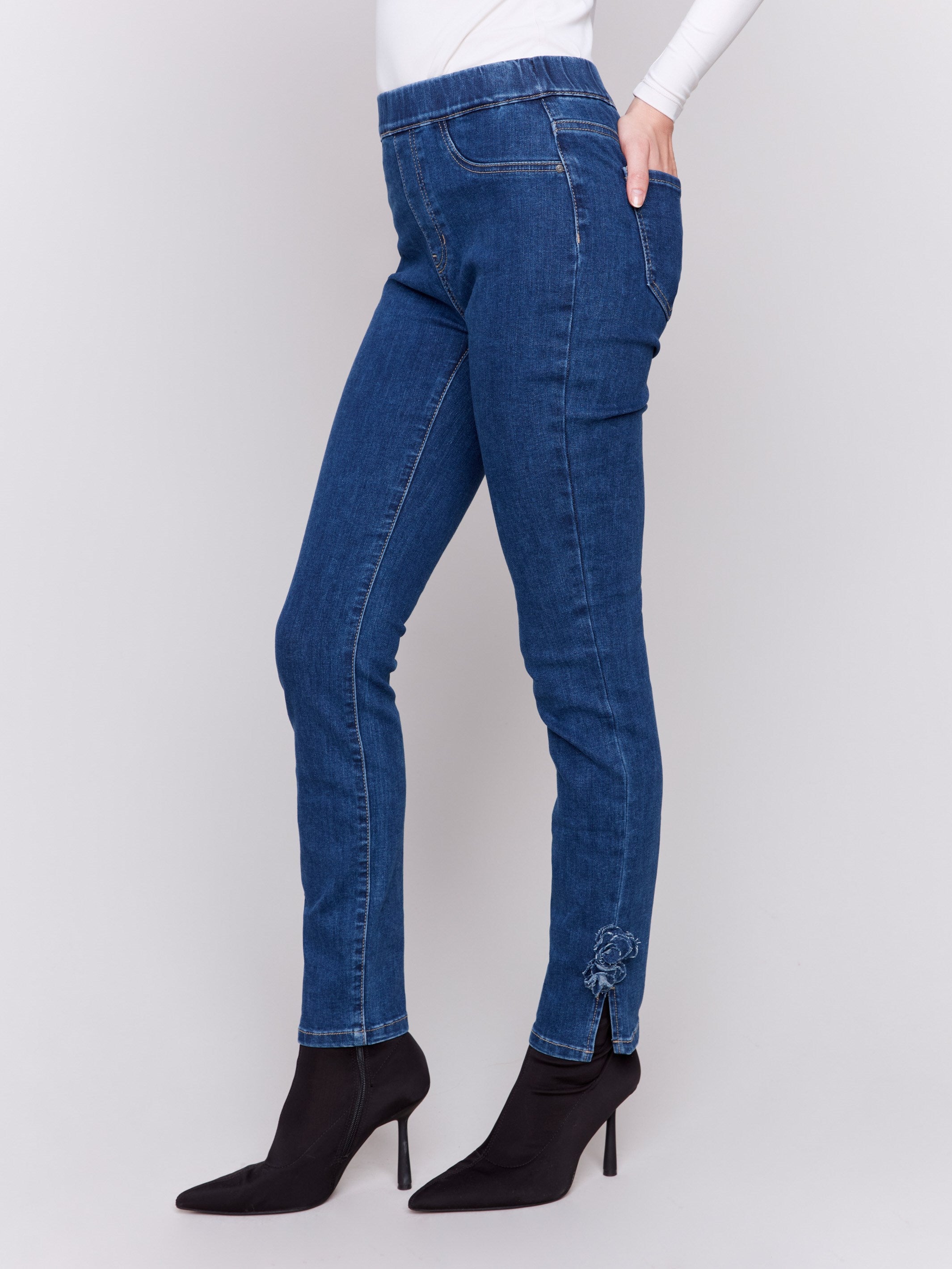 Indigo jeans with slim leg featuring side rose embroidery and side slits by Charlie B.