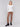 Ecru white V-neck sweater with long sleeves featuring side slits, made from plushy yarn by Charlie B.