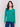 Forest green V-neck sweater with long sleeves featuring side slits, made from plushy yarn by Charlie B.