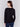 Black V-neck sweater with long sleeves featuring side slits, made from plushy yarn by Charlie B.