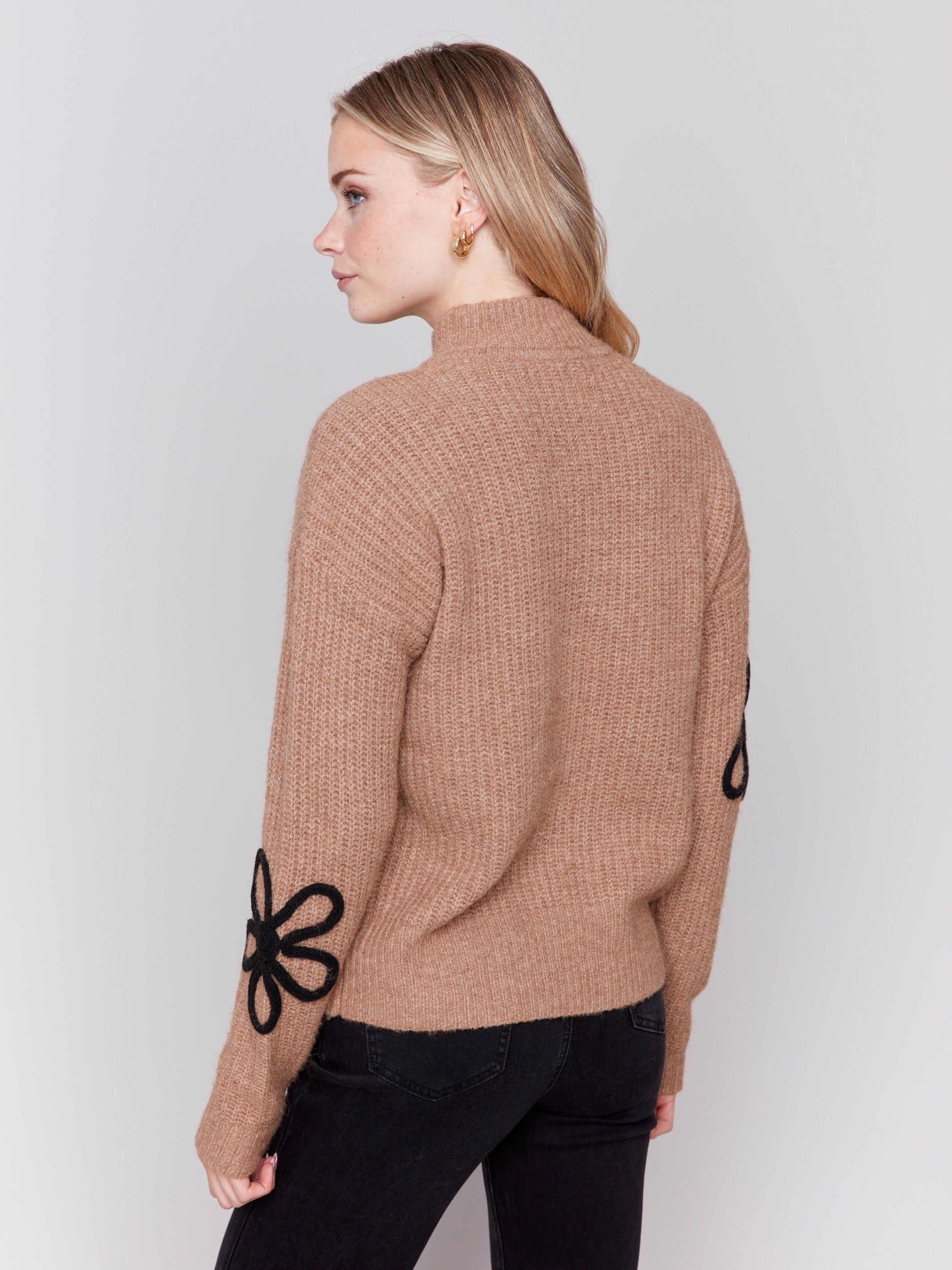 Truffle brown mock-neck sweater with black floral embroidery and ribbed texture by Charlie B.