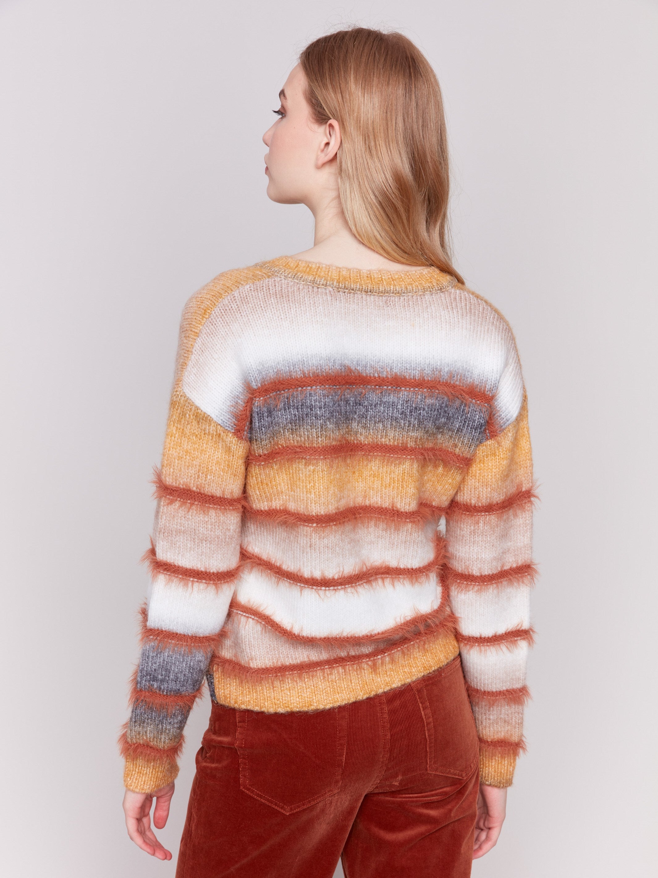 Amber-colored sweater with a subtle V-neck and a striped pattern made of eyelash yarn by Charlie B.