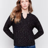 Speckled black cable knit sweater by Charlie B with a notched neckline and long sleeves.