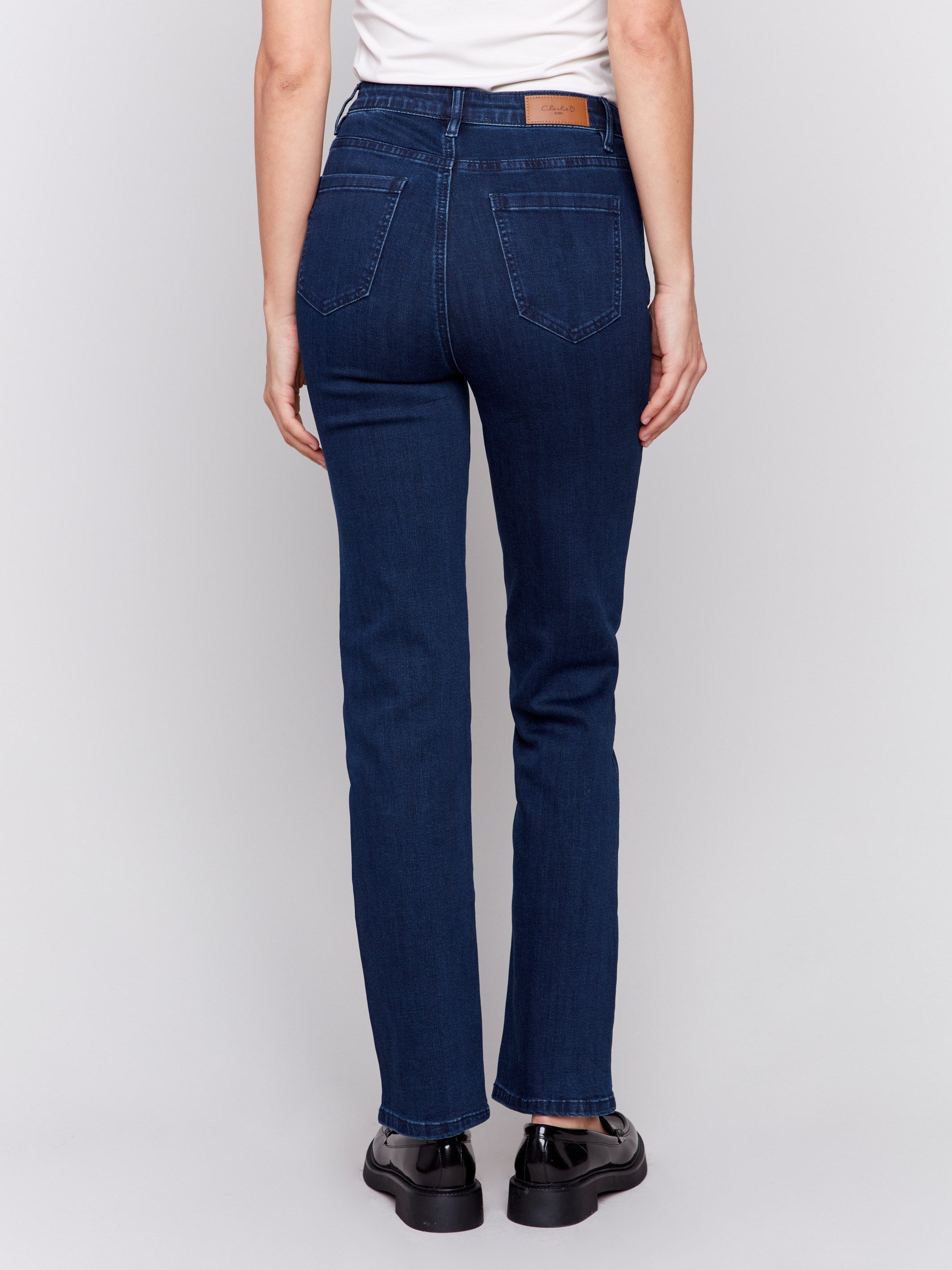 Classic dark blue denim jeans with a straight-leg design, mid-rise, and elastic waistband for women by Charlie B.