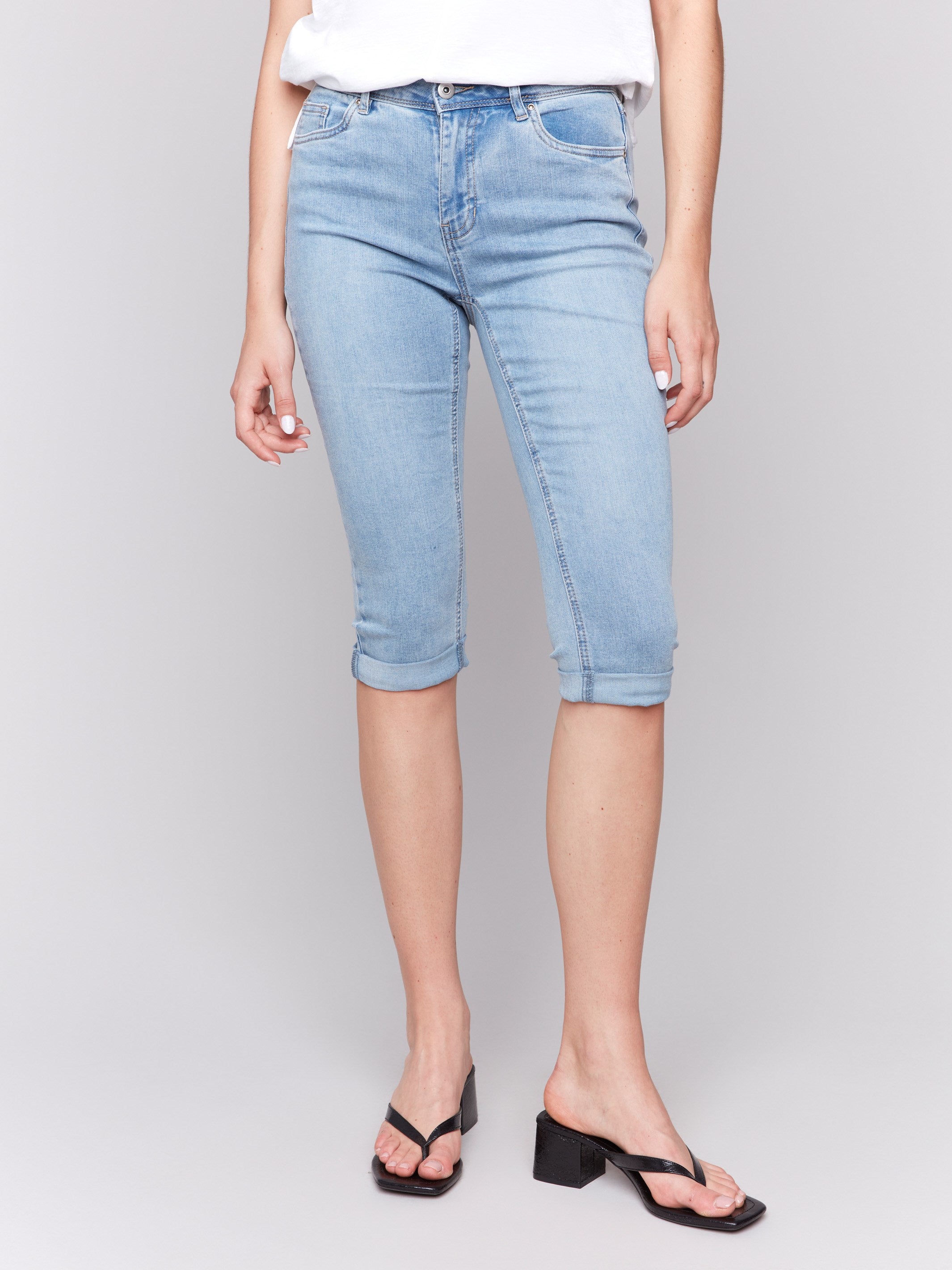 Blue denim pants featuring a mid-rise waist and stretch fabric for comfort by Charlie B.