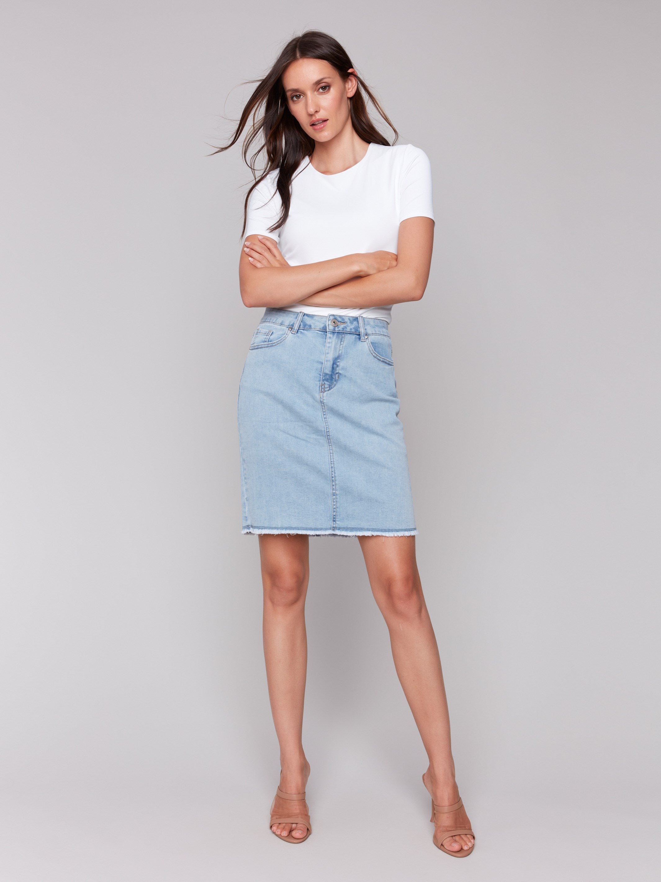 Frayed hem detail adds a trendy touch to the denim skort by Charlie B.