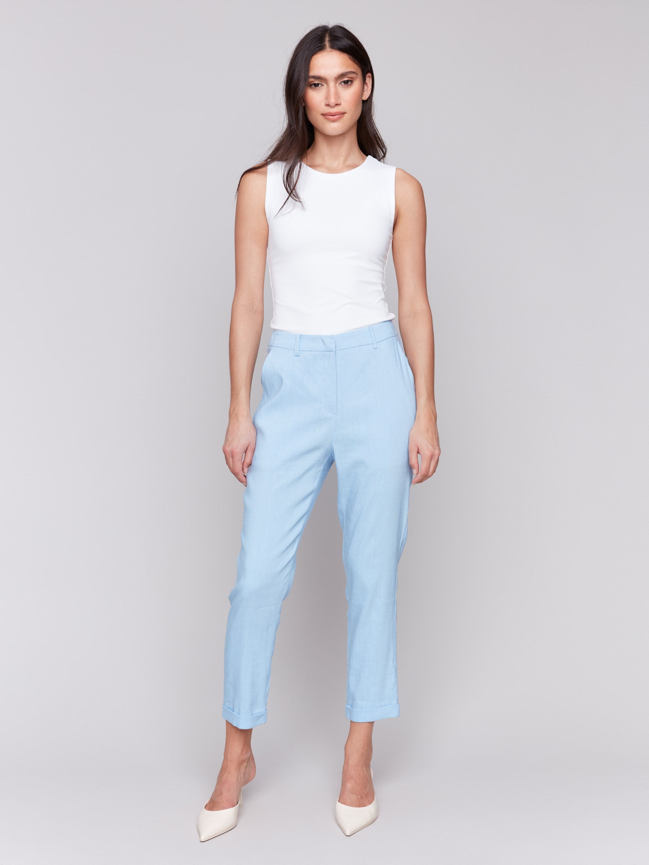 Light blue cropped pants with cuffed hem and slash pockets by Charlie B.