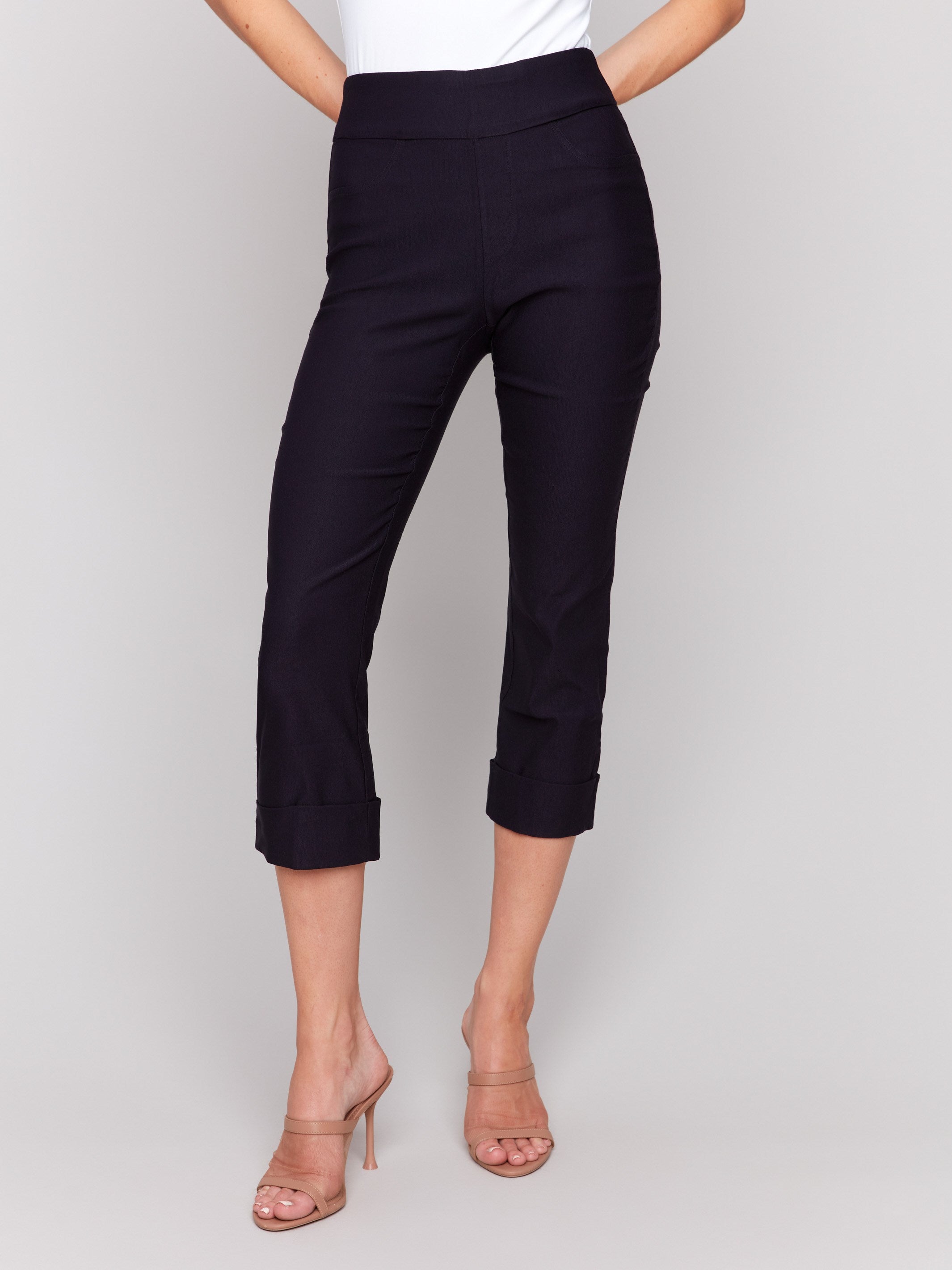 Cropped navy capri pants featuring a sleek slim leg style by Charlie B.