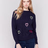 Navy blue sweater adorned with mini heart embroidery, featuring a crew neck and long sleeves by Charlie B.