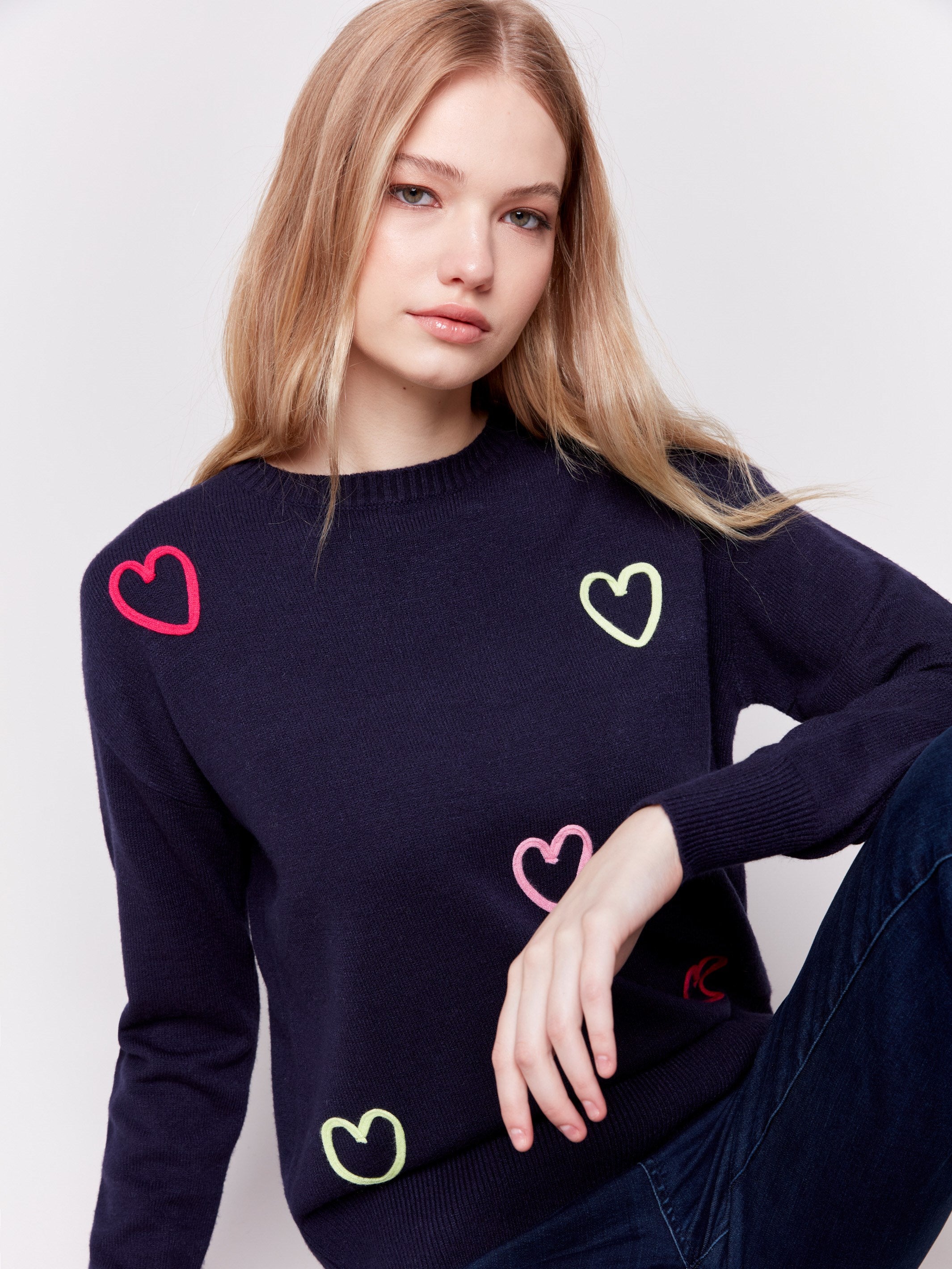 Navy blue sweater adorned with mini heart embroidery, featuring a crew neck and long sleeves by Charlie B.