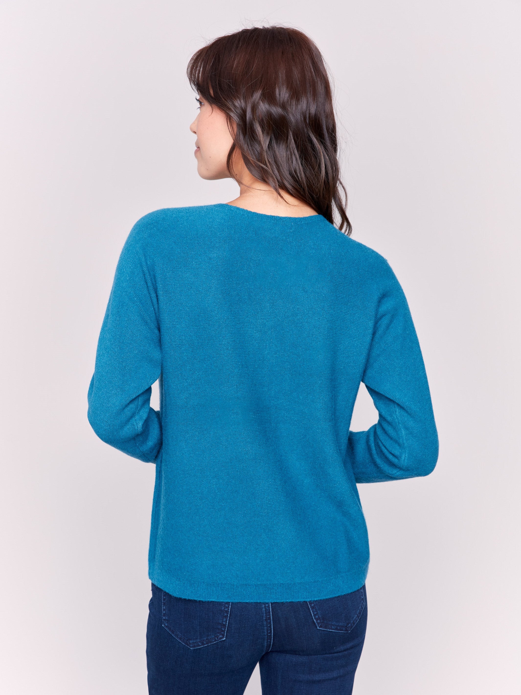 Peacock long-sleeve sweater with fringed embroidery, featuring a round neckline and ribbed cuffs by Charlie B.