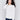 Ecru white sweater with long sleeves featuring side tab details and a round hem by Charlie B.