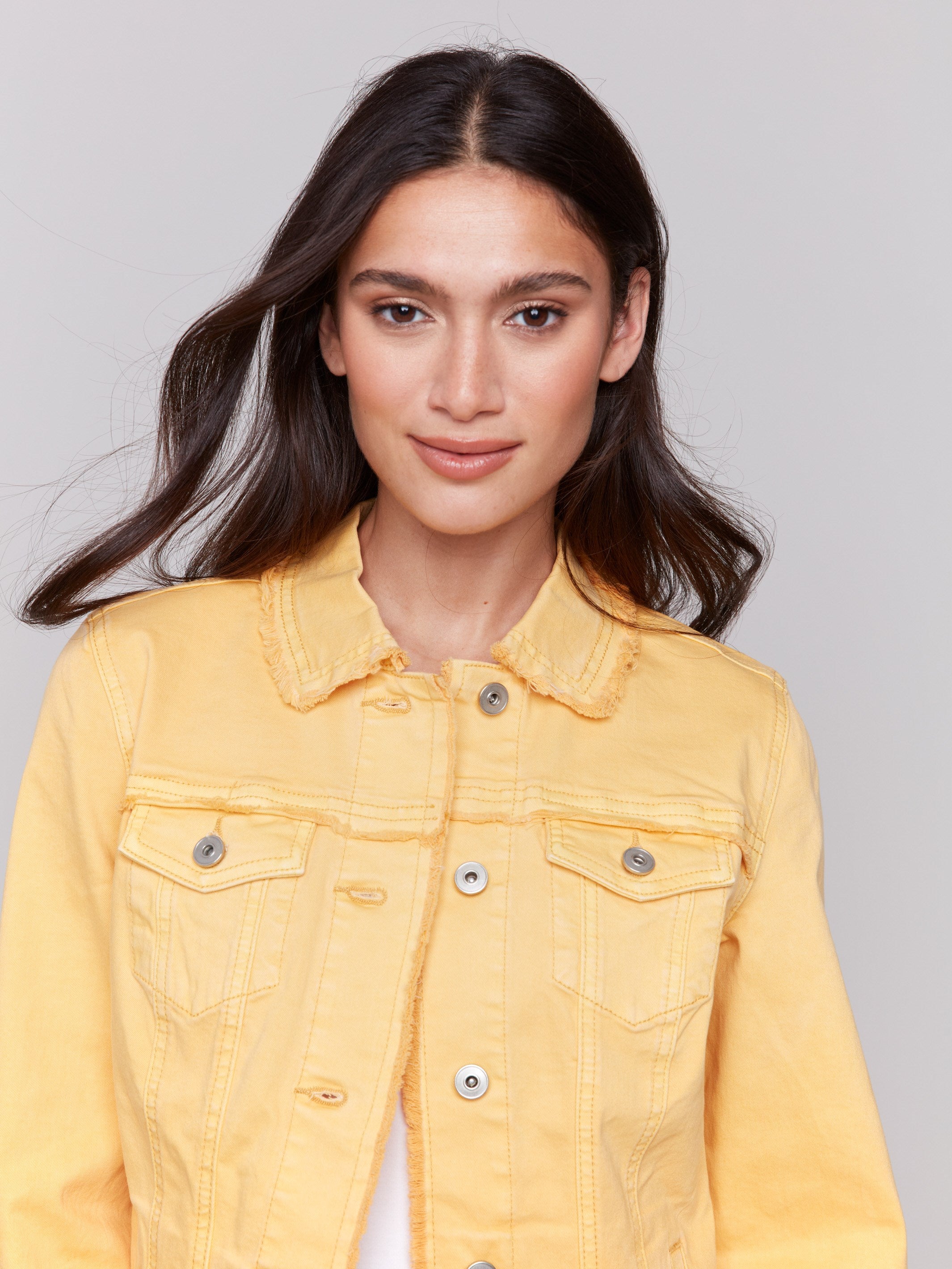 Lemon yellow twill jean jacket with frayed edges and front pockets by Charlie B.