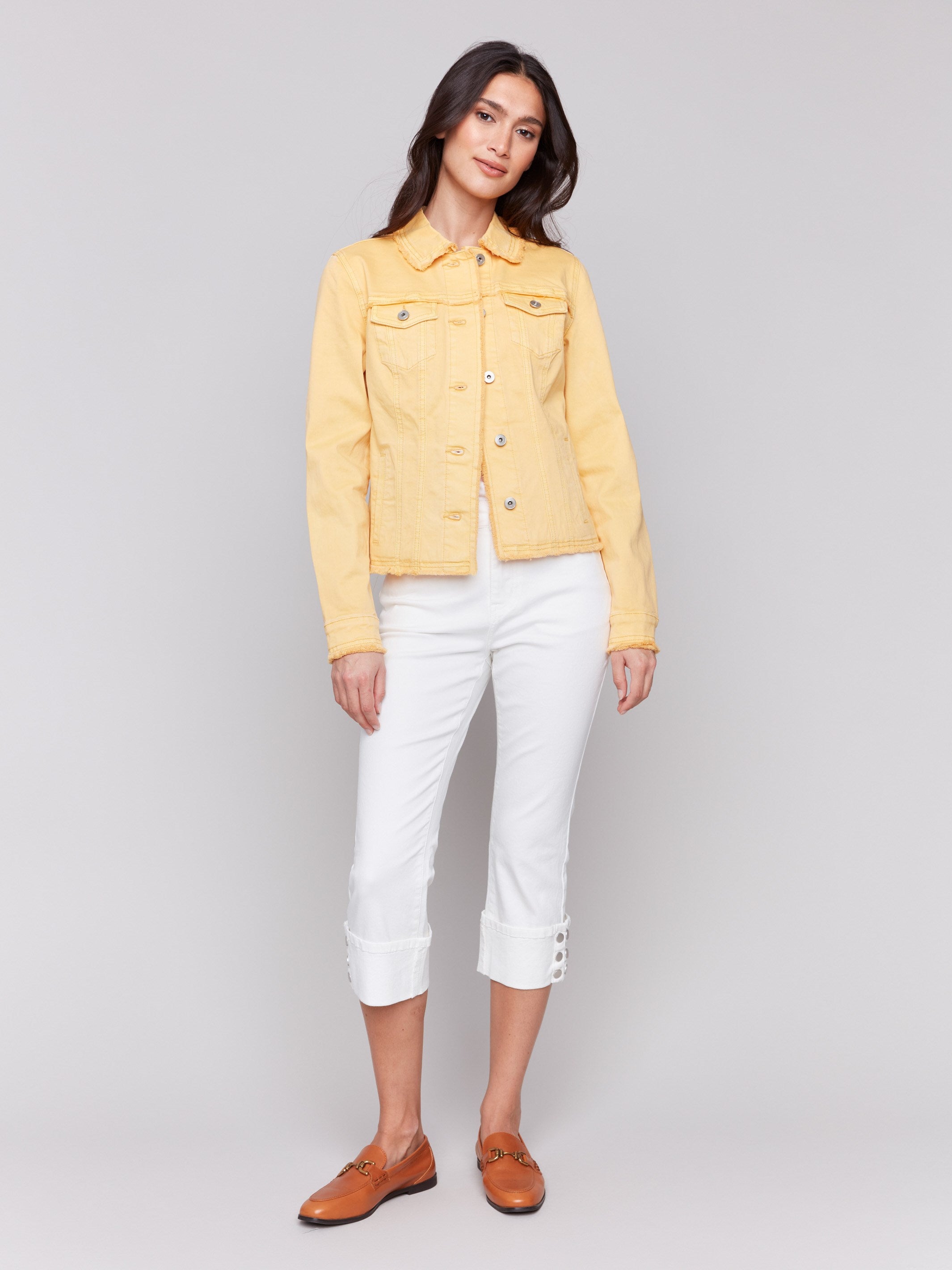 Lemon yellow twill jean jacket with frayed edges and front pockets by Charlie B.