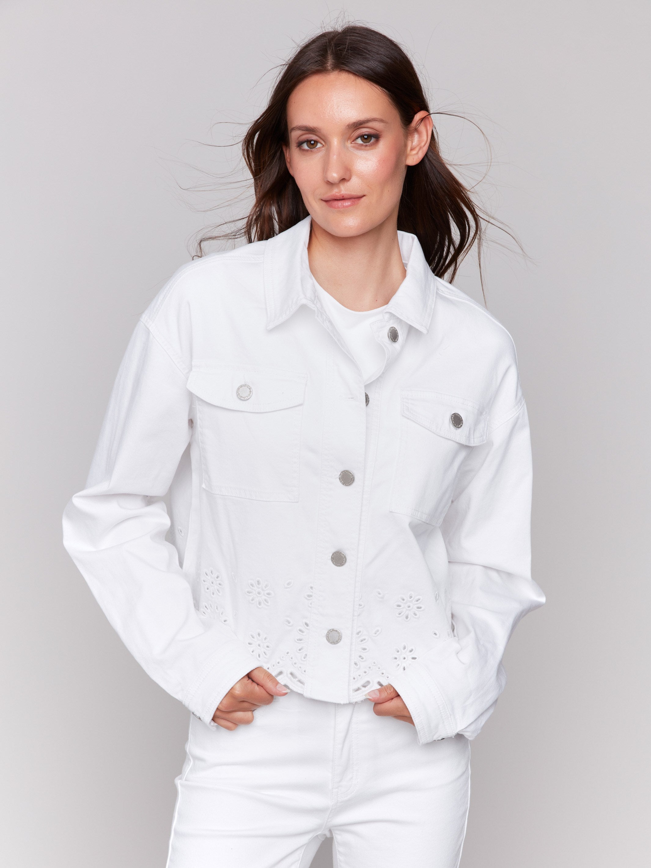 Elegant white jacket showcasing scalloped hem and eyelet details by Charlie B.