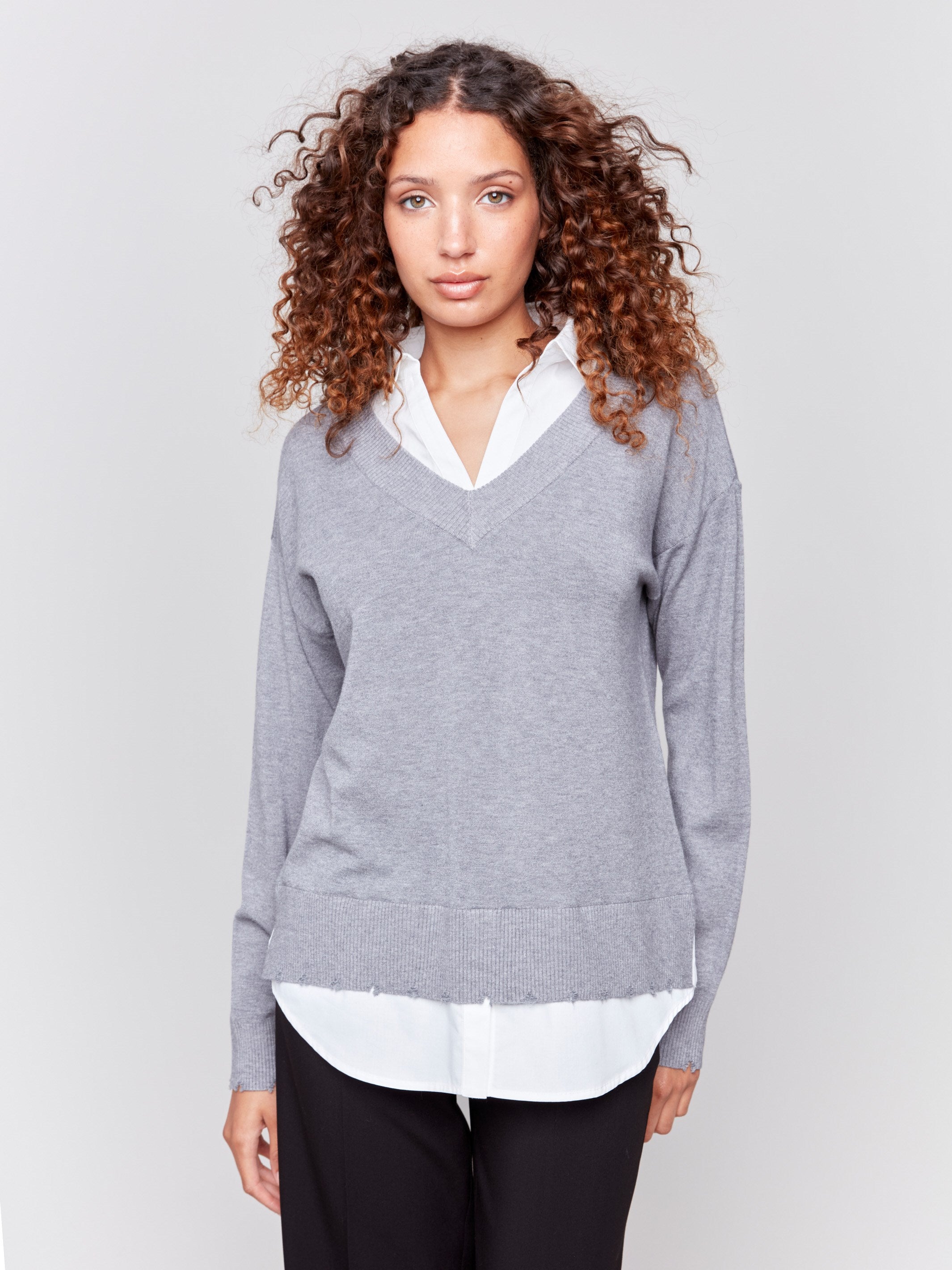 Grey V-neck fooler sweater with white shirt collar, featuring a shirttail hem and side slits by Charlie B.