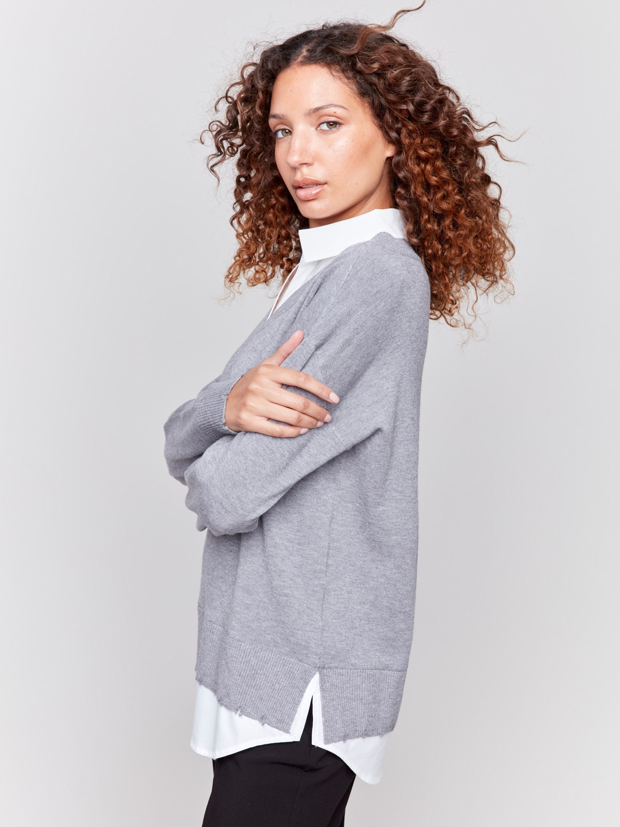 Grey V-neck fooler sweater with white shirt collar, featuring a shirttail hem and side slits by Charlie B.