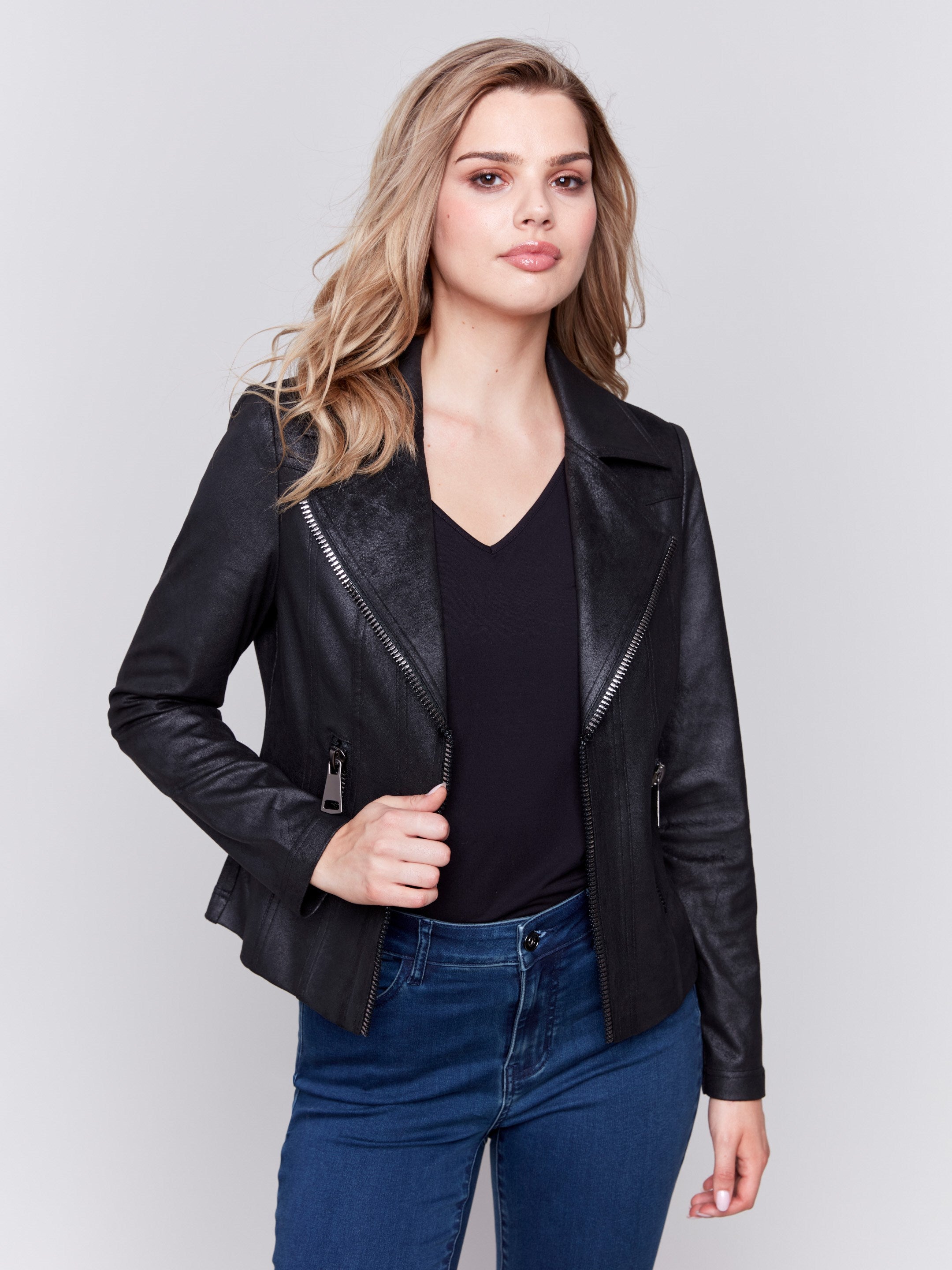 Black faux leather biker jacket with zipper details and fake pockets by Charlie B.