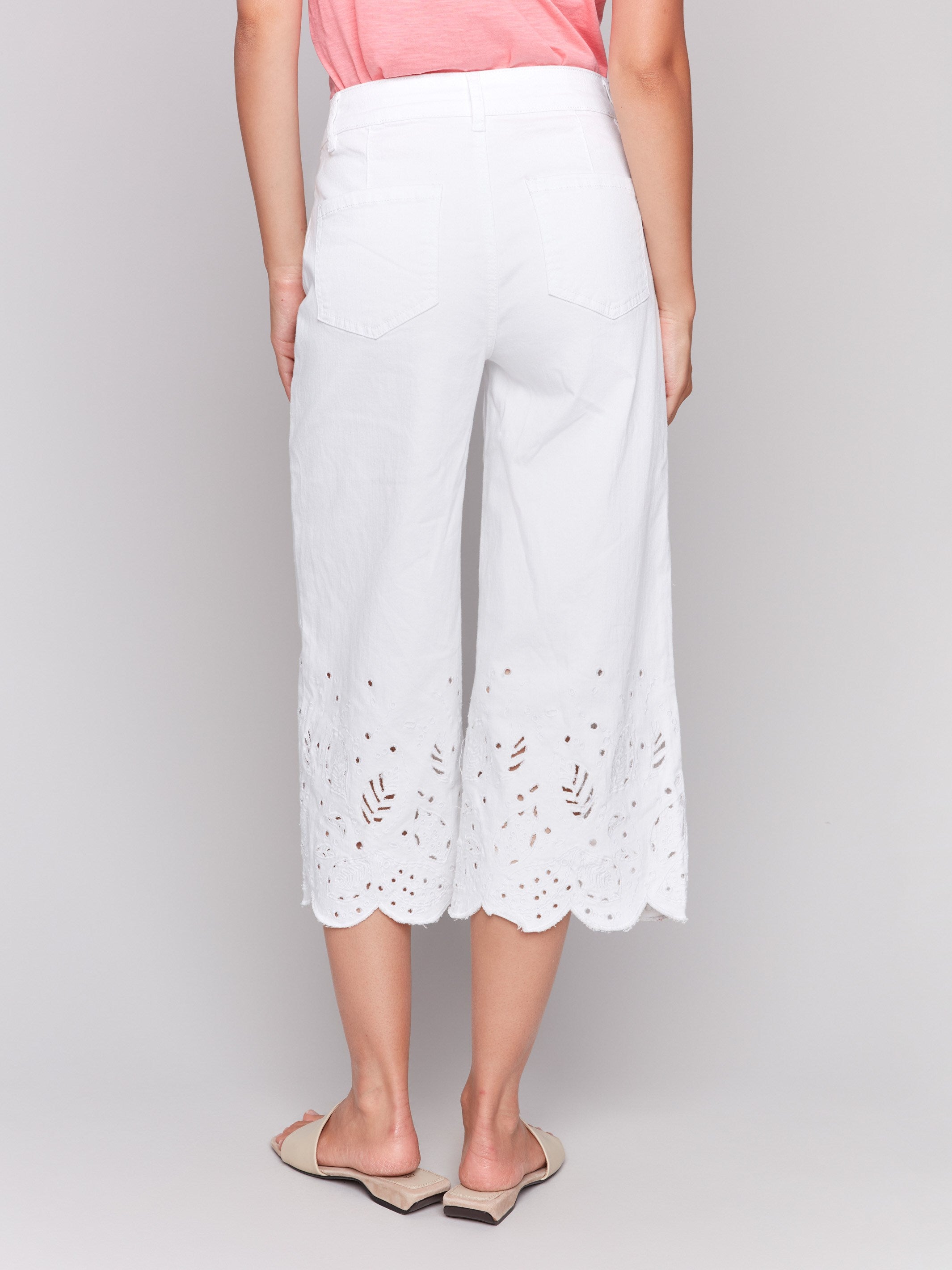 Scallop embroidered hem adds elegance to these cropped white jeans by Charlie B.